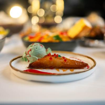 Cheese puff pastry with apple served with pistachio ice cream.