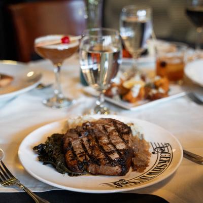 pork chop with drinks in backround.