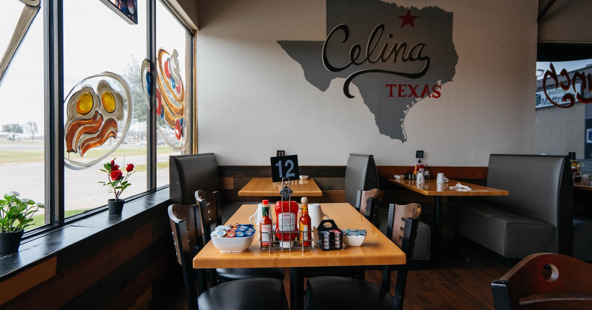 Interior, table for four in front, seating booths with tables in the back, shop window