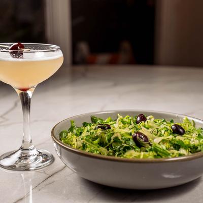 Mixed Green Salad and Santorini Sour cocktail.