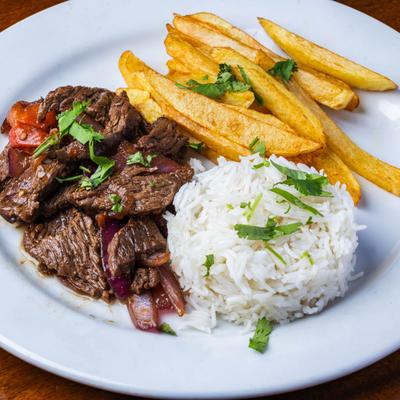 Lomo Saltado with rice and fries.
