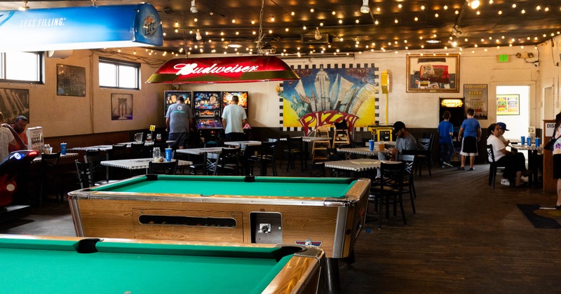 Interior, pool tables, dining area in the back