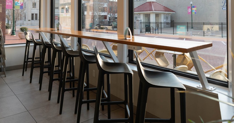 Interior, wooden table with stools by the window with a view
