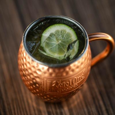 Moscow Mule in a copper mug, garnished with a lime wheel.
