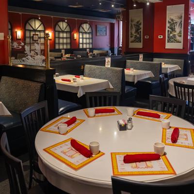 Dining room booths with round table in the foreground.