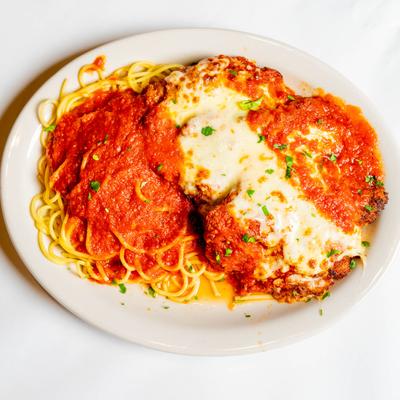 Veal Parmigiana, with tomato sauce, mozzarella, and pasta.