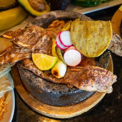 Grilled beef on top of grilled onions and nopales.