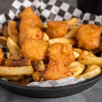 Fried Sea Scallops served over fries.