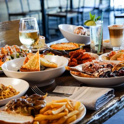 Various dishes served on the table with drinks.