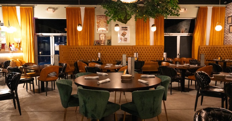 Interior, wide view of dining area, tables ready for guests