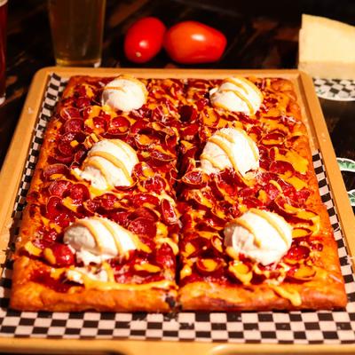 Pepperoni pizza topped with burrata cheese.