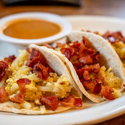 Bacon Breakfast Tacos with a side of green chile.