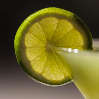 Lime on the edge of the martini cocktail.