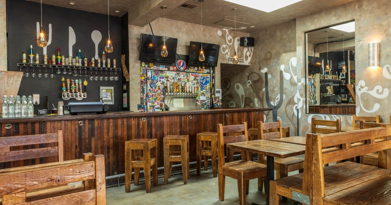 Bar and chairs, tv's above, diner area with tables