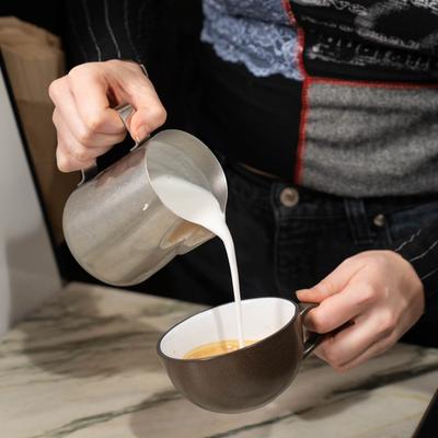 A hand preparing a drink.