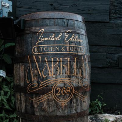 Outside, patio direction sign, a barrel.