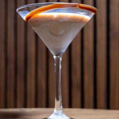 Chocolate martini against a wood-paneled background.