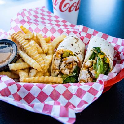 Buffalo Chicken Wrap served with fries and a dip.