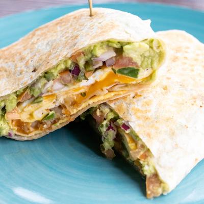 Burrito with scrambled eggs, hash browns, salsa, avocado, jalapenos, and cheddar.