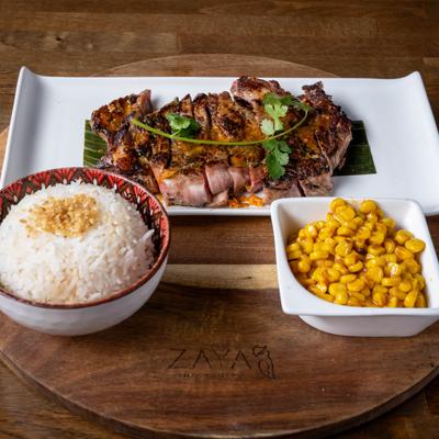 Grilled ribeye steak, with garlic rice and corn.