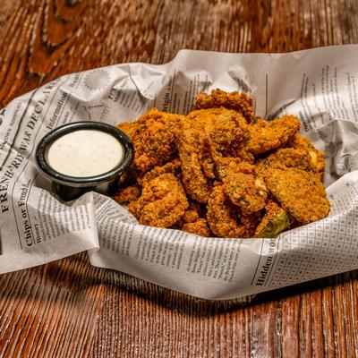 Fried pickles served with a dipping sauce.