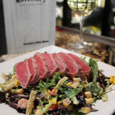 Seared Ahi tuna, with rice, tomatoes, carrots, cucumbers, spicy lime aioli, avocado, and scallions.