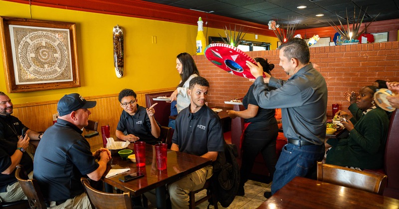 Interior, a group of uniformed officers dining