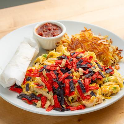 Migas served with hush browns and a dipping sauce.