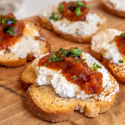 Goat Cheese Crostini topped with a sweet tomato jam, and balsamic.