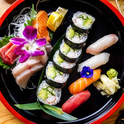 Assorted sushi, sashimi, rolls, wasabi, and pickled ginger..