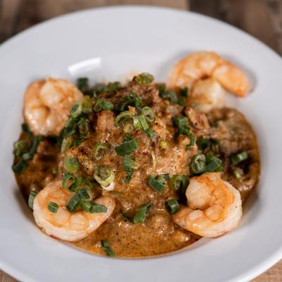 Crawfish etouffee with shrimp and diced green onions.