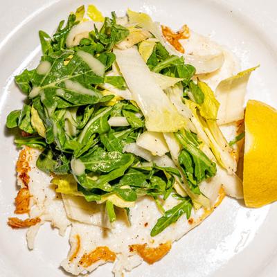 Grilled chicken breast topped with arugula salad and shaved parmesan.