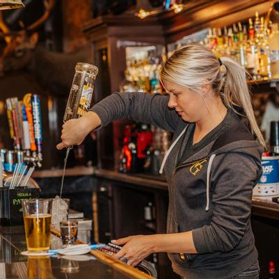 A staff member making a cocktail