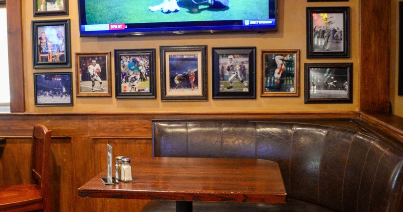 Interior, tables, upholstered benches, chairs, LED TV, framed photos of athletes