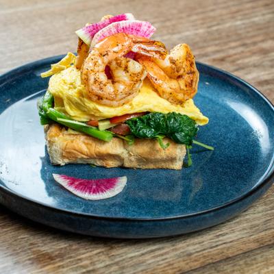 Shrimp Avo Toast served on a blue plate.