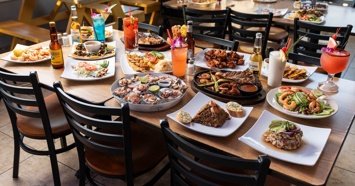 Colorful spread of Mexican dishes and cocktails