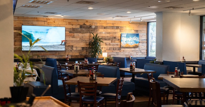 Dining area, tables ready for guests, TV on the wall