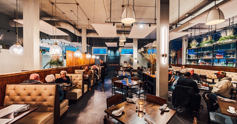 Restaurant interior, dining area, guests chatting and enjoying their food and drinks