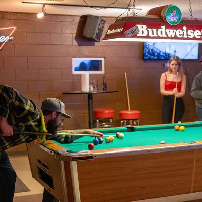 Interior, customers playing pool.