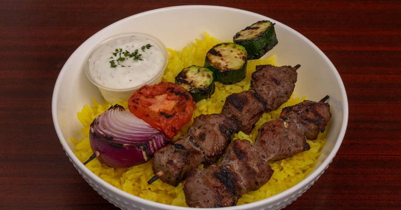 Beef kabobs with grilled vegetables, yellow rice and tzatziki