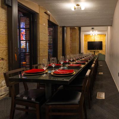 Interior, a long, prepared dining table in a rustic restaurant interior.