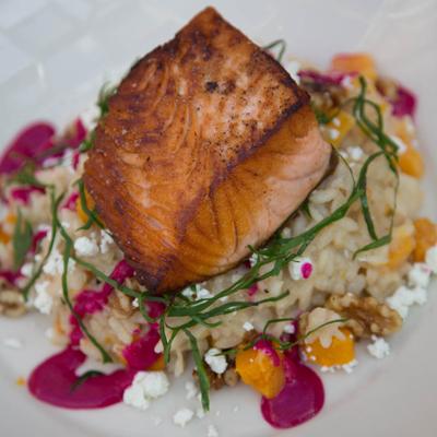 Salmon on a bed of risotto.