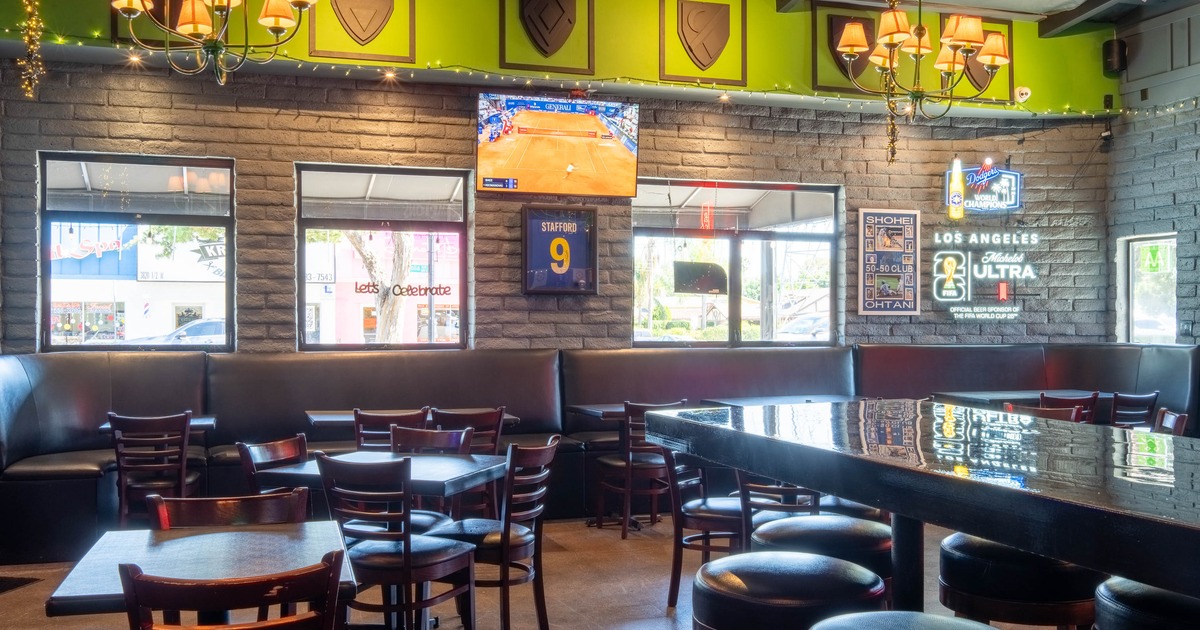 Interior of a lively bar with wooden tables and chairs