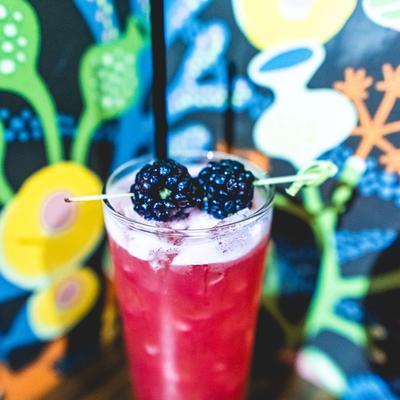 Purple cocktail with fruit on top