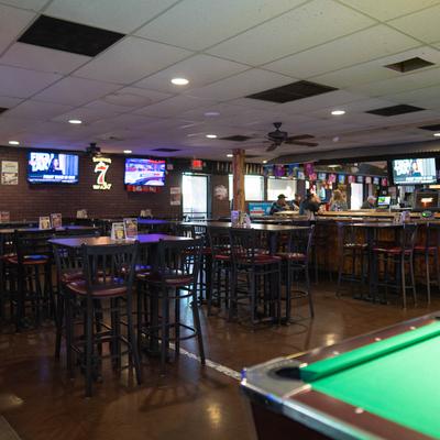 Interior with high-top seating, TVs, and a pool table.