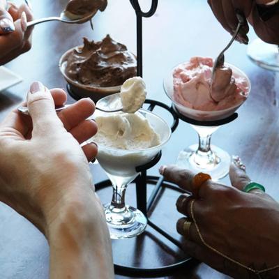 People enjoying ice cream, closeup on the ice cream.