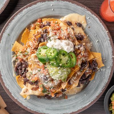Nachos with guacamole and jalapenos on top