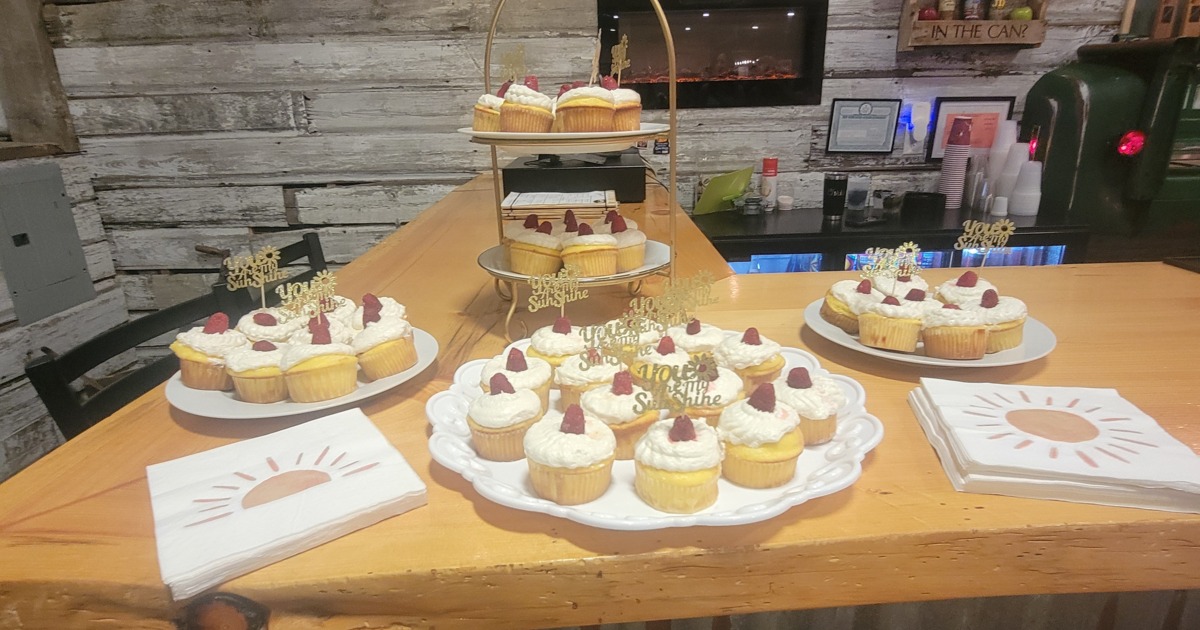 Cupcakes displayed on wooden dessert table