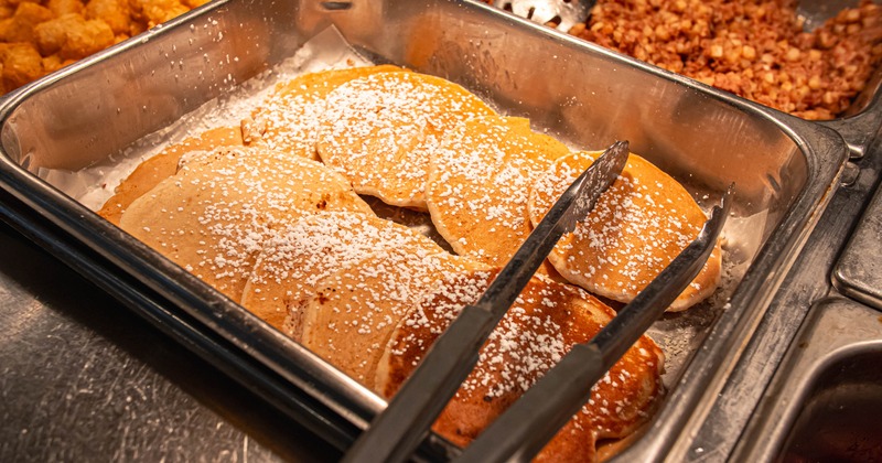 Powdered pancakes in a stainless buffet tray
