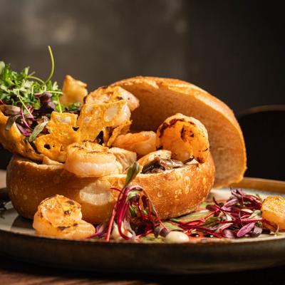 Bread bowl filled with a truffle alfredo sauce, grilled shrimp, mushrooms and bacon.